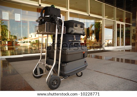 Trolley with suitcases in front of hotel