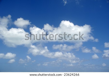 Cloudscape with white cumulus clouds and a blue sky.