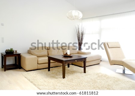 stock photo : A modern living room with table, sofa and armchair.