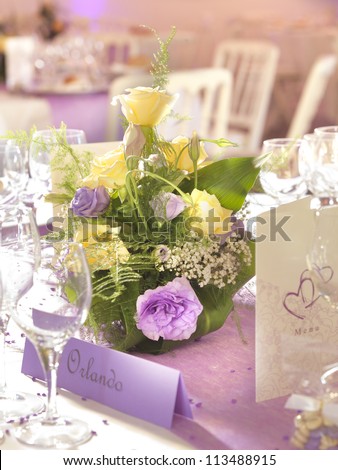 Wedding decoration with flowers and place card in yellow and violet