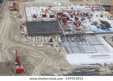 concrete construction with digger, trucks and bulldozer