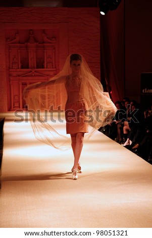AMMAN, JORDAN - APRIL  12:  model wears clothes made by Italian designer of Palestinian descent Jamal Taslaq during a fundraiser fashion show for a local charity on April 12, 2010 in Amman, Jordan.