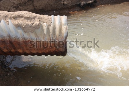 dirty pollution waste pipe on water closeup