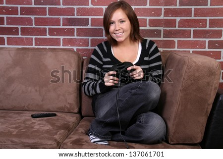 women playing video game on couch