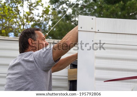 Worker repairing mobile home