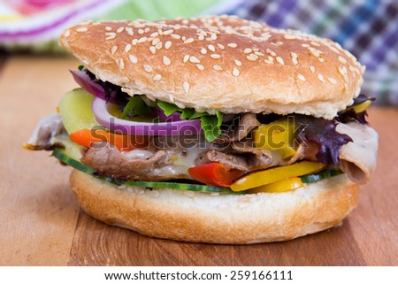 philly cheese steak burger sandwich with vegetables