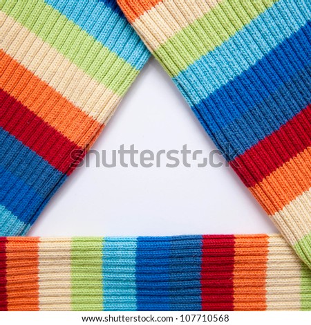 Triangular frame of multicolored knitted fabric. Can be used for your logo or symbol, a fashion and beauty.