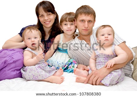 Happy smiling young big family, five people - mother, father, elder daughter and two twins baby girls isolated on white background