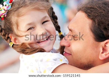 Happy father and daughter hugging each other and laughing. Family love and care concept