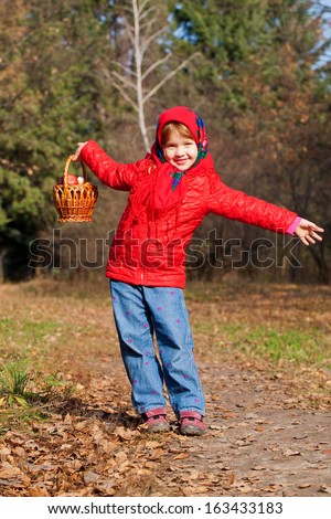 Happy smiling little girl in the autumn forest. Harvest concept.