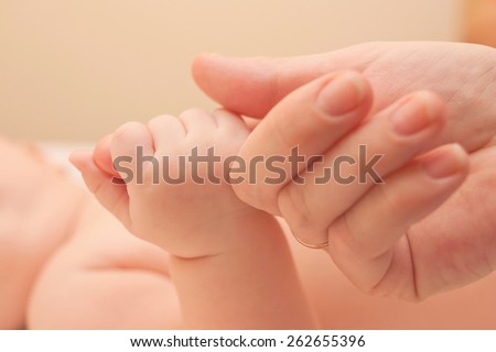 Baby and mothers hands. Family and love concept.