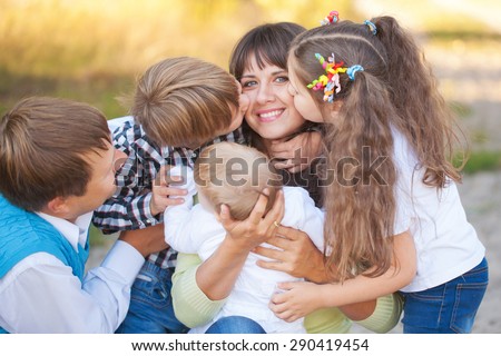 Large family hugging and having fun outdoors. Summer vacation.