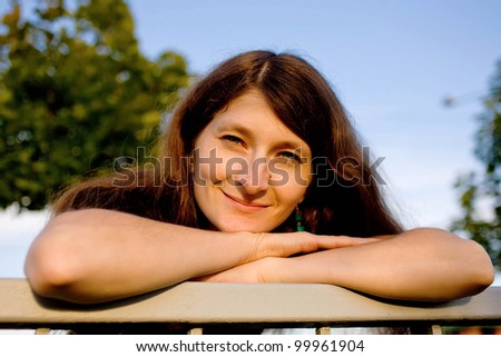 Portrait of pretty dark-haired woman propping up her face,Summer holiday.