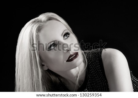 Black and white portrait of a beautiful blonde woman isolated on black background