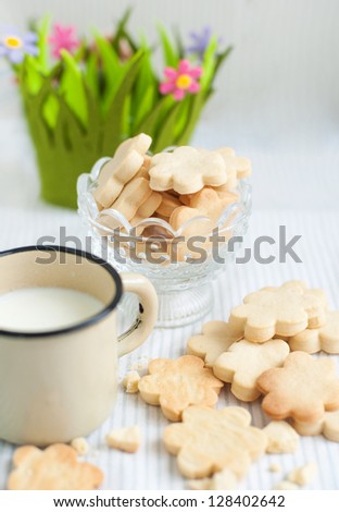 breakfast with sweet cookies  and milk, focus in on a vase