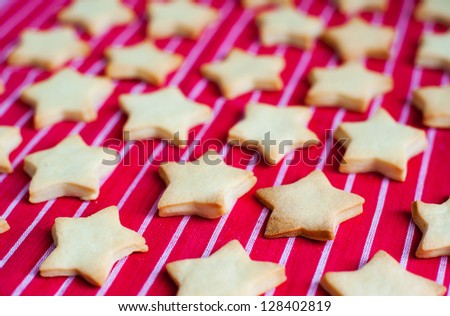 star cookies on a red table