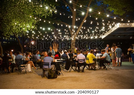 NEW YORK CITY - June 10: Customers dine at Shake Shack in Madison Square Park June 10, 2014 in New York, NY. The chain diner opened in 2004 and the Madison Square Park location is the original.