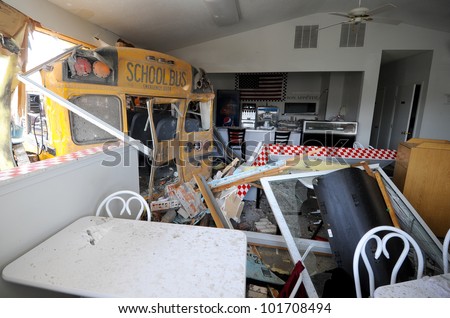 HENRYVILLE, IN - MARCH 3 : A school bus rests in a diner across the street from the high school, Saturday March 3, 2012, in Henryville, Ind. After an F4 tornado hit the city.
