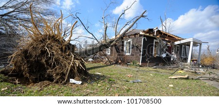 HENRYVILLE, IN - MARCH 3 : A tree rest on a tornado damaged home Saturday March 3, 2012 in Henryville, Ind.