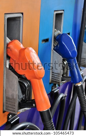 Several gasoline pump nozzles at petrol station, gasoline industry