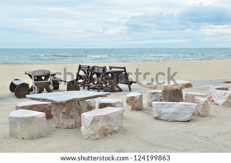 Stone and Wooden chair on beautiful tropical beach