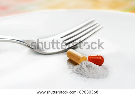 A opened pill on a plate representing a diet pill.