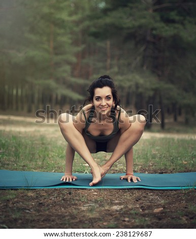 beautiful girl is engaged in yoga in the forest