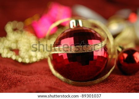 Christmas tree ball and golden ribbon on the background of Christmas ornaments