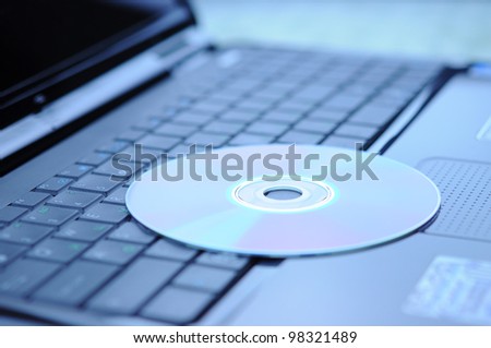 DVD disk lying on a laptop keyboard