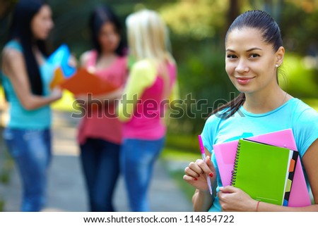 pretty student outdoors with a group of people on the background