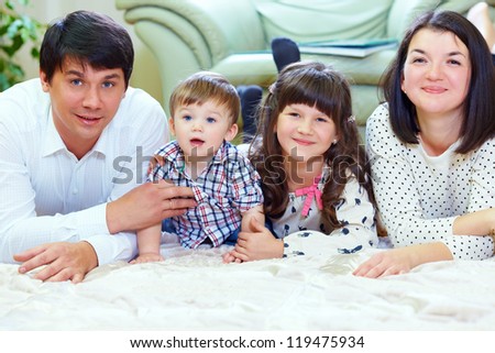 happy family of four persons at home