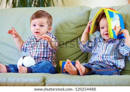 two cute baby boys playing with toys at home two cute baby boys playing with toys at home
