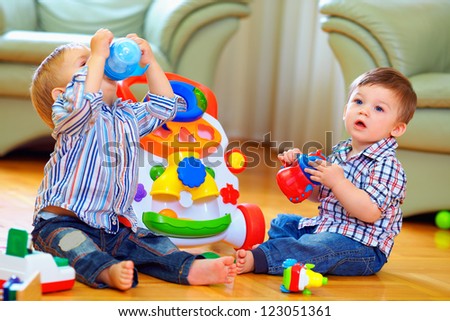 cute funny baby boys playing with toys at home cute funny baby boys playing with toys at home