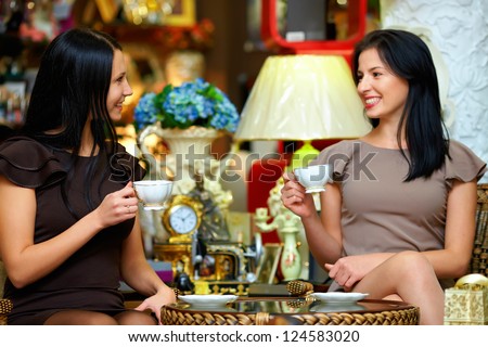 two elegant ladies have a tea break in retro cafe two elegant ladies have a tea break in retro cafe