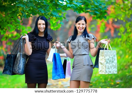 two happy laughing women after shopping