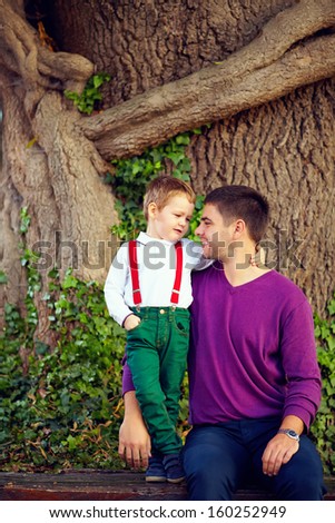 portrait of father and son in front of old tree