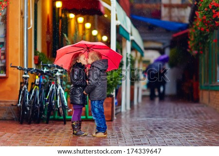 Cute Young Couple Kissing Under The Rain