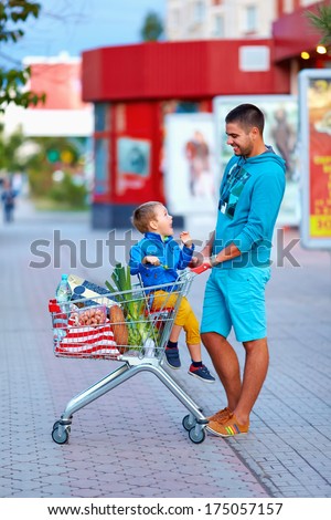 happy father and son after shopping in supermarket