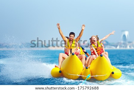Happy People Having Fun On Banana Boat