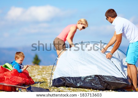 family set up a camp in mountains, active lifestyle