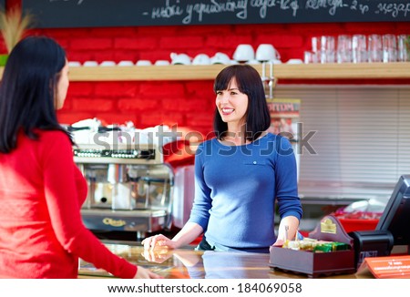 waitress serves customer in coffee shop