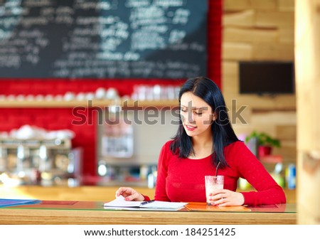 beautiful girl studying in cafe
