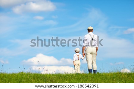 father and son look beyond the horizon
