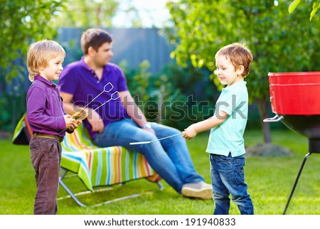 happy kids fighting with kitchen items on picnic