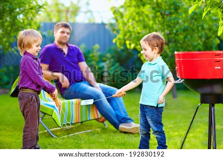 happy kids fighting with kitchen items on picnic