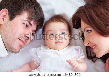 portrait of happy family in bed