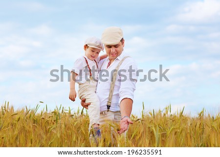 father and son, farmers on wheat field