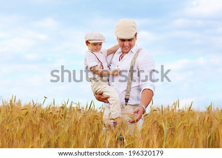 father and son, farmers on wheat field