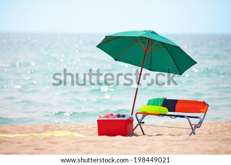 folding furniture and ice box on summer beach