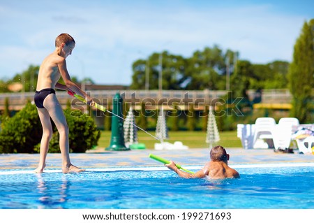 happy kids having fun, playing in water park